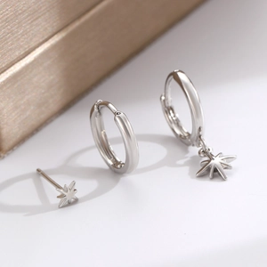 Macro shot of silver moon and star earring set with polished finish and cubic zirconia