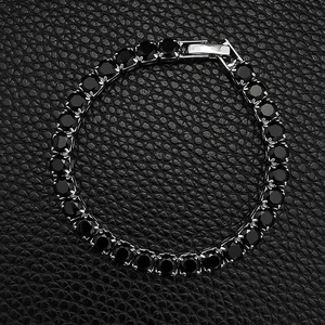 Macro shot of silver tennis bracelet featuring black round cubic zirconia and safety clasp