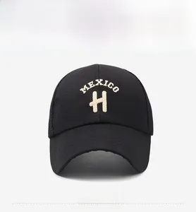 Close-up of black baseball cap with white Mexico H embroidery and breathable mesh back