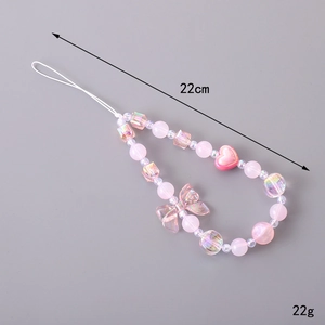Pink beaded phone charm with acrylic bow and heart pendant, 22cm long and 22g