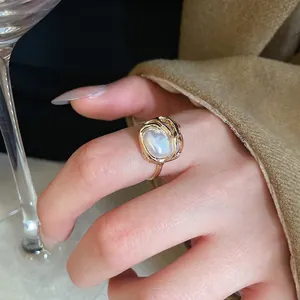 Lava design gold ring with large baroque pearl worn by model in elegant setting