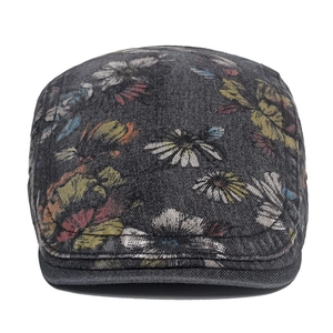Close-up detail of vintage floral printed washed denim newsboy cap with embroidery