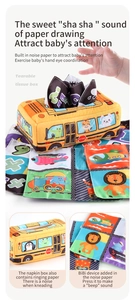 Detail of baby tissue box toy featuring a yellow bus with colorful crinkle paper inserts
