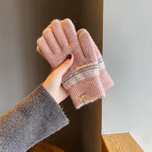 Detail of pink knitted glove showing warm thermal fleece lining and jacquard pattern