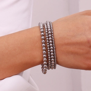 Macro view of multi-layer silver beaded elastic bracelet with a metallic gradient finish