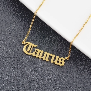 Macro detail of gold Taurus zodiac pendant on O-chain with a black and white background