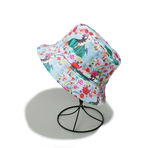 Detailed close-up of blue canvas bucket hat with floral print and portrait patterns
