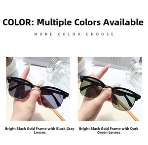 Detail view of retro semi-rimless Clubmaster sunglasses with black and gold metal frames