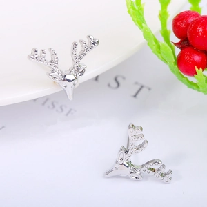 Detailed macro view of silver reindeer stud earrings with crystal rhinestones for Christmas