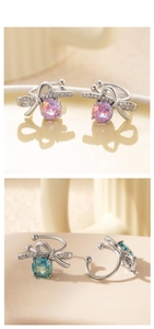 Macro detail of U-shaped bow ear cuffs with pink and blue stones and sparkling accents