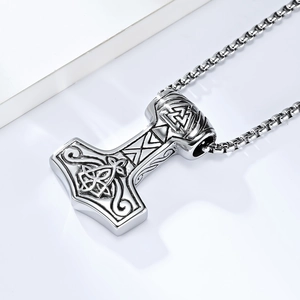 Macro shot of Viking Mjolnir pendant with intricate Norse runes and geometric details