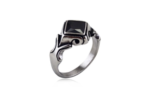 Macro detail of gothic stainless steel ring with black gemstone and vintage engravings