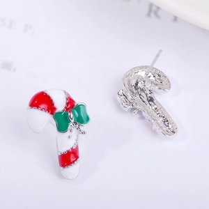 Detail of candy cane earrings with red and white enamel and a green bow accent