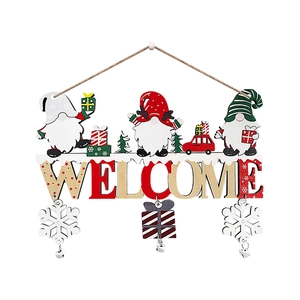 Detail of wooden Christmas door sign with Nordic Gnomes and Welcome text for home decor