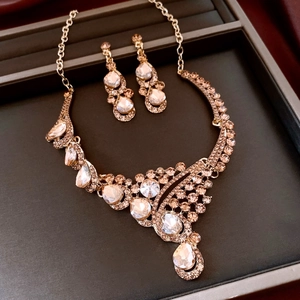 Macro shot of French vintage gold necklace and earring set with shimmering crystals