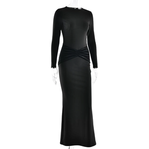 Detail of waist twist and ruching on a black slim-fit floor-length long sleeve dress