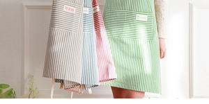 Detail view of cotton linen striped aprons with large front pockets in four colors