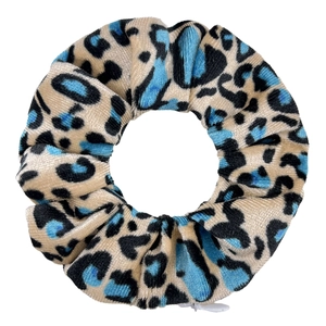 Detail shot of leopard print velvet hair scrunchie with hidden zipper pocket on white base