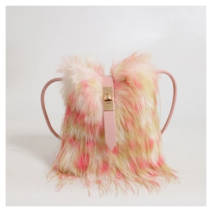 Detail of pink and beige plush handbag with leather strap and golden metal clasp