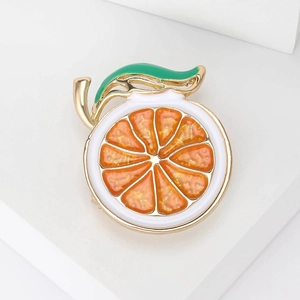 Fashionable enamel orange slice brooch with golden alloy frame and green leaf detail