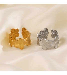 Detailed view of flower shaped open rings in gold and silver finish with textured petals