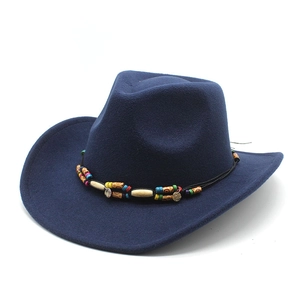 Detail of dark navy blue felt cowboy hat featuring bohemian beaded ethnic hatband