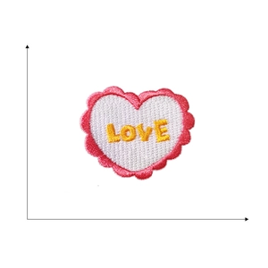 Self-adhesive embroidered heart patch with pink border and yellow LOVE text for DIY decor