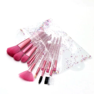 Detail view of 12-piece pink makeup brush set with glitter handles and clear PVC pouch