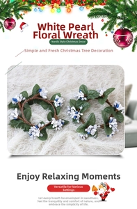 Close-up of artificial Christmas candle rings with white and blue berries and green leaves