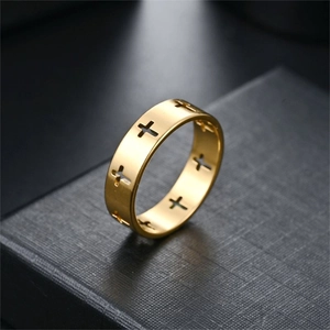 Detailed macro view of the gold-finished cutout cross pattern on a minimalist ring