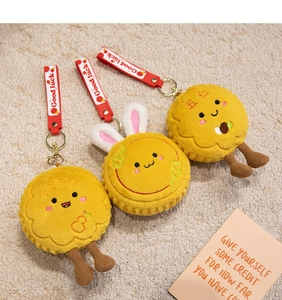 Close-up of cute plush bunny mooncake charms with Good Luck embroidery and red straps