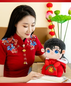 Detailed view of a cute boy plush doll in a festive red outfit for New Year mascot gifts
