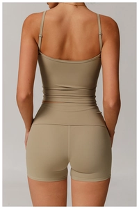 Detail view of khaki yoga set showing back cut of the slim-fit top and high-waisted shorts