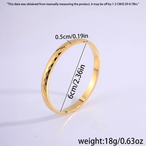 Detail showing dimensions of the gold geometric bangle with 6cm diameter and 0.5cm width