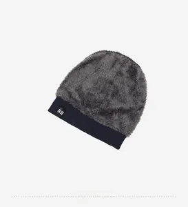 Close-up of winter knit hat with dark grey faux fur lining and blue ribbed ear flaps