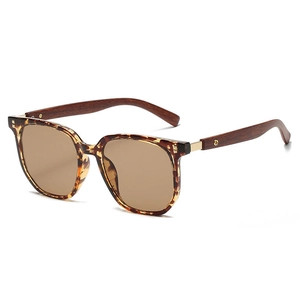 Detail view of retro polygon sunglasses featuring leopard tortoise frame and wood grain temples