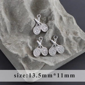 Detail of three rhodium-plated tennis racket charms with white cubic zirconia inlays