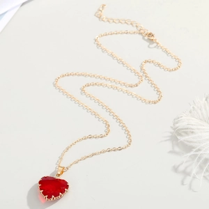 Minimalist gold chain necklace with faceted red heart pendant and lobster clasp detail