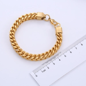 Detail shot of a 12mm wide golden Franco chain bracelet with ruler for size measurement