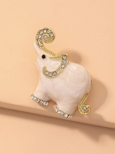 Macro shot of cute cartoon elephant brooch with sparkling rhinestones and gold plating