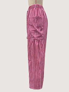 Detailed view of elastic waist and side pocket on pink and red striped casual pants