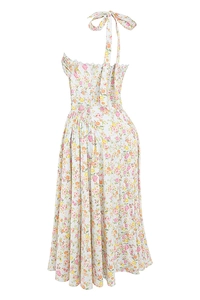 Detail of floral printed white maxi dress showing halter neck bow tie and pleated waist
