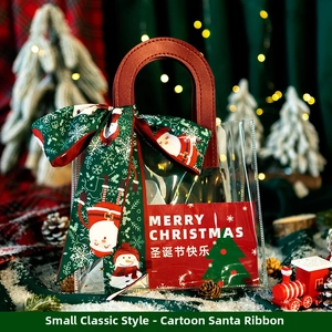 Detailed view of Christmas themed PVC gift bag with Santa Claus motif and red handle