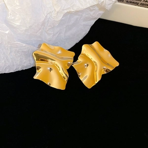 Detail view of gold irregular crinkled square earrings with high polish mirror texture