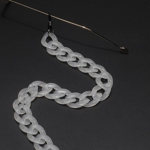 Detail of white translucent acrylic glasses chain with rubber loops on gold metal temples