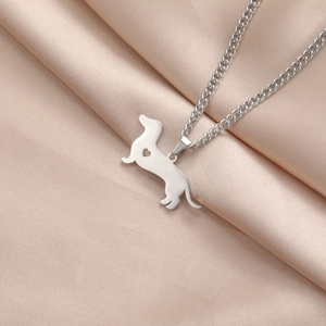 Macro view of silver dachshund pendant with heart cutout on a stylish link chain