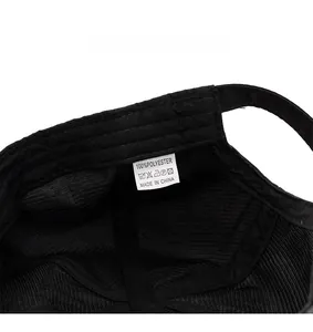 Detail view of the breathable mesh interior and care label on this black polyester beret