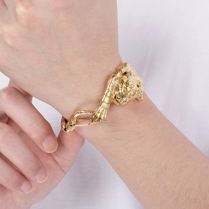 Close-up of vintage gold tiger head bracelet in titanium steel worn by a male model