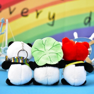 Rear view of three cute panda plush keychains with leaf scarf and red hood accessories