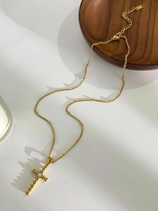 Detailed view of 18K gold plated cross pendant with zircon and adjustable chain link